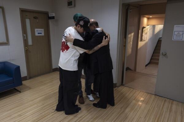 Jang Dae-chang hugs his daughter, Nicole Motta, and her family at the Eastern Social Welfare Society in Seoul on Friday, May 31, 2024, following their emotio<em></em>nal first meeting. Motta, whose Korean name is Jang Hyeon-jung, was adopted by a family in Alabama, United States, in 1985. (AP Photo/Jae C. Hong)