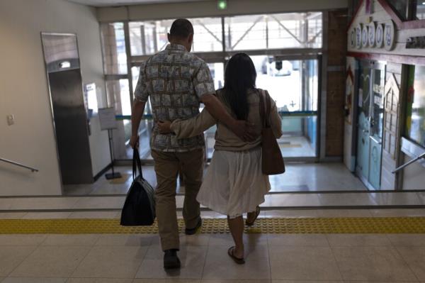 Kenneth Barthel, left, who was abando<em></em>ned and later adopted to the United States at 6 years old, and his wife, Napela, comfort each other as they leave the Busan Metropolitan City Child Protection Center in Busan, South Korea, Friday, May 17, 2024, after searching for docu<em></em>ments that could lead to finding his birth family. (AP Photo/Jae C. Hong)