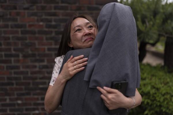 Maja Andersen, an adoptee visiting from Denmark to search for her birth family, hugs Sister Christina Ahn at Star of the Sea orphanage in Incheon, South Korea, Monday, May 20, 2024, while visiting the facility to look for details of her adoption. She had loved being hugged, the orphanage docu<em></em>ments said, and had sparkling eyes. "Thank you so much, thank you so much," Andersen repeated in a trembling voice. There was comfort in that, she had been hugged, she had smiled. (AP Photo/Jae C. Hong)