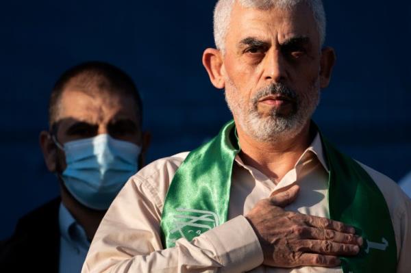 Yahya Sinwar, Palestinian leader of Hamas in the Gaza Strip, places his hand over his heart on stage after greeting supporters at a rally of supporters days after a cease-fire was reached in an 11-day war between Gaza's Hamas rulers and Israel, Monday, May 24, 2021, in Gaza City, the Gaza Strip. (AP Photo/John Minchillo)