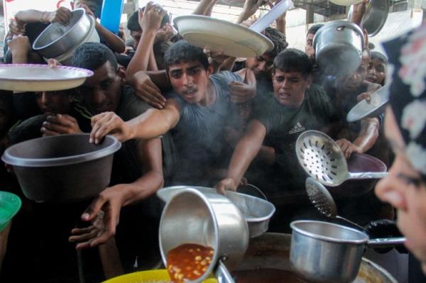 Palestinians gather to receive food assistance in Gaza