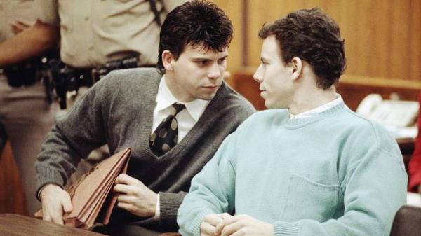 Lyle Menendez, left co<em></em>nfers with brother Erik during a court appearance, April 2, 1991 in Beverly Hills, California. Lawyers for the brothers won another delay of a preliminary hearing while they seek a state Supreme Court opinion on whether an alleged murder co<em></em>nfession is protected by doctor-patient privilege. (AP Photo/Kevork Djansezian)


