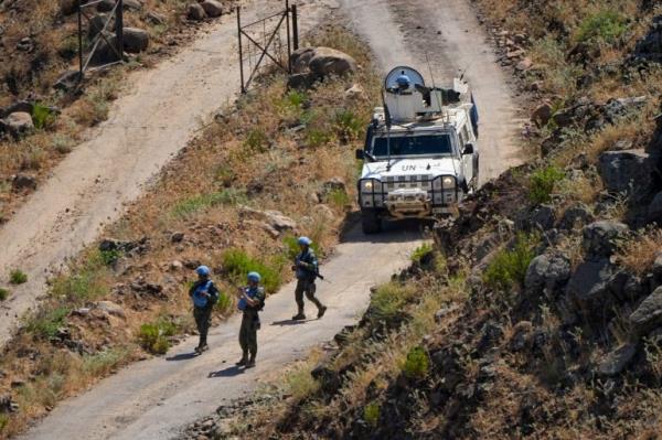 FILE -UN peacekeepers (UNIFIL) seen along the Lebanese side of the border with Israel, seen from Israel, Thursday, July 6, 2023. (AP Photo/Ariel Schalit, File)