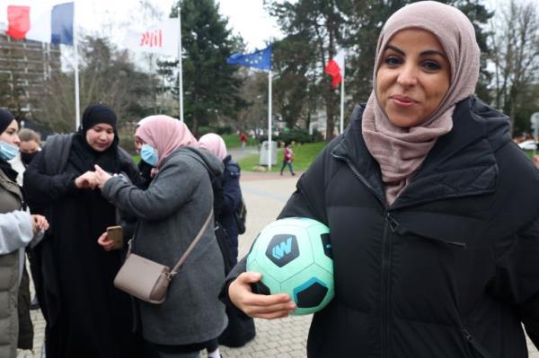 Writer Majid Siham poses with a soccer ball