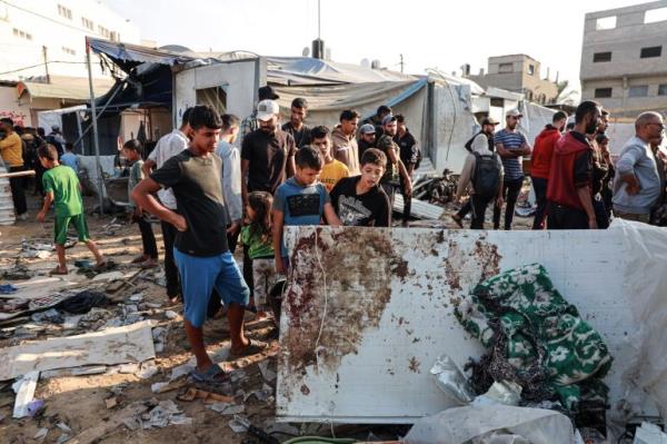 People survey the aftermath of the attack