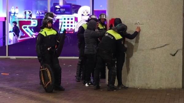 In this image taken from video, police frisk pro-Palestinian supporters near the Ajax stadium in Amsterdam, the Netherlands, Thursday, Nov. 7, 2024. (AP Photo InterVision)