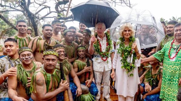 King Charles and Queen Camilla with members of a cricket team during a visit to the Samoan Cultural Village in Apia.
Pic: PA