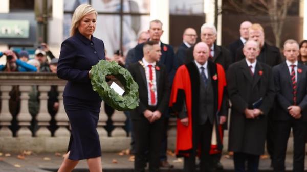 First Minister Michelle o<em></em>neill lays a wreath at Belfast City Hall. Pic: PA