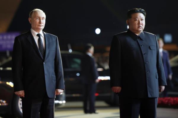 Russian President Vladimir Putin, left, and North Korea's leader Kim Jong Un stand together during the departure ceremony at an internatio<em></em>nal airport outside Pyongyang, North Korea, on Wednesday, June 19, 2024. (Gavriil Grigorov, Sputnik, Kremlin Pool Photo via AP)