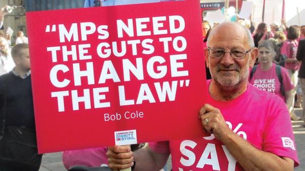 Mick Murray holding up a quote from Bob at a Dignity in Dying protest. Pic: Dignity in Dying