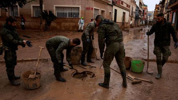 Army perso<em></em>nnel clean a drainage system blocked by mud in Paiporta, Valencia. Pic: Reuters