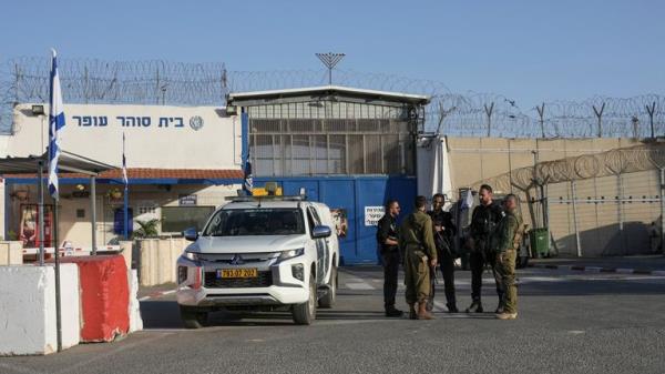 Israeli soldiers stand outside Ofer military prison near Jerusalem on Friday, Nov. 24, 2023. Friday marks the start of a four-day cease-fire in the Israel-Hamas war, during which the Gaza militants pledged to release 50 hostages in exchange for 150 Palestinians impriso<em></em>ned by Israel. (AP Photo/Mahmoud Illean)