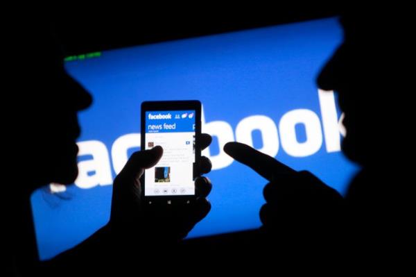 A smartphone user shows the Facebook application on his phone in the central Bosnian town of Zenica, in this photo illustration, May 2, 2013.