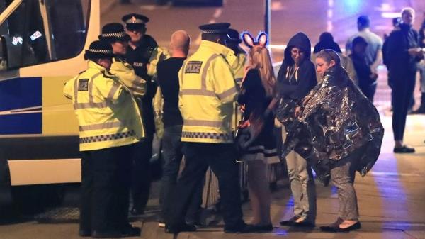 Police are seen with members of the public after the attack. Pic: PA