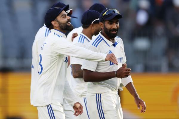 PERTH, AUSTRALIA - NOVEMBER 22: Virat Kohli and Jasprit Bumrah of India embrace as they walk off the field at the end of play on day one of the First Test match in the series between Australia and India at Perth Stadium on November 22, 2024 in Perth, Australia. (Photo by Cameron Spencer/Getty Images)