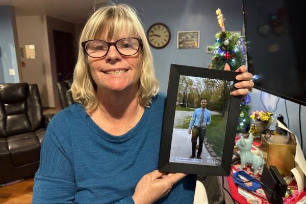 Timmerman's mother holds up a photo of him