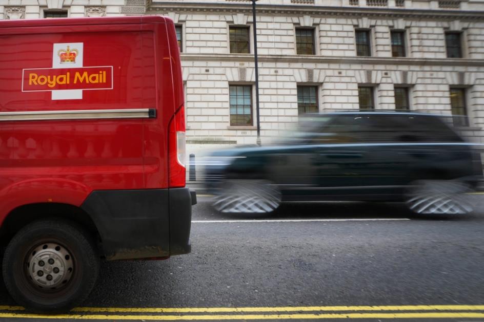 A car overtakes a Royal Mail delivery van, in Westminster in London, Thursday, Jan. 25, 2024. Royal Mail could save millions by moving to three-day-a-week service. Ofcom are 'not credible' in the debate around post office reforms, CWU general secretary Dave Ward said on Wednesday in respo<em></em>nse to Ofcom proposals which could see Royal Mail delivery services cut down to as little as three days a week. (AP Photo/Kirsty Wigglesworth)