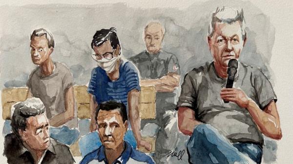 A court sketch of Dominique Pelicot speaking during his trial with his fellow defendants behind him. Pic: Reuters