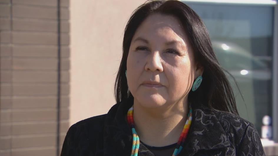 Woman stands outside building