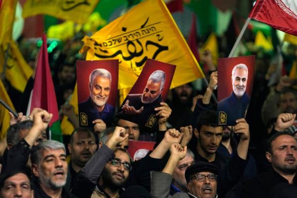 Protesters in Tehran. They are holding up posters of Iranian Revolutio<em></em>nary Guard Gen. Qassem Soleimani, who was killed in a US drone attack in 2020.