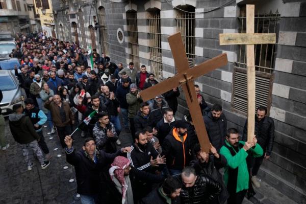 Syrian Christians carry crosses and shout slogans in Damascus