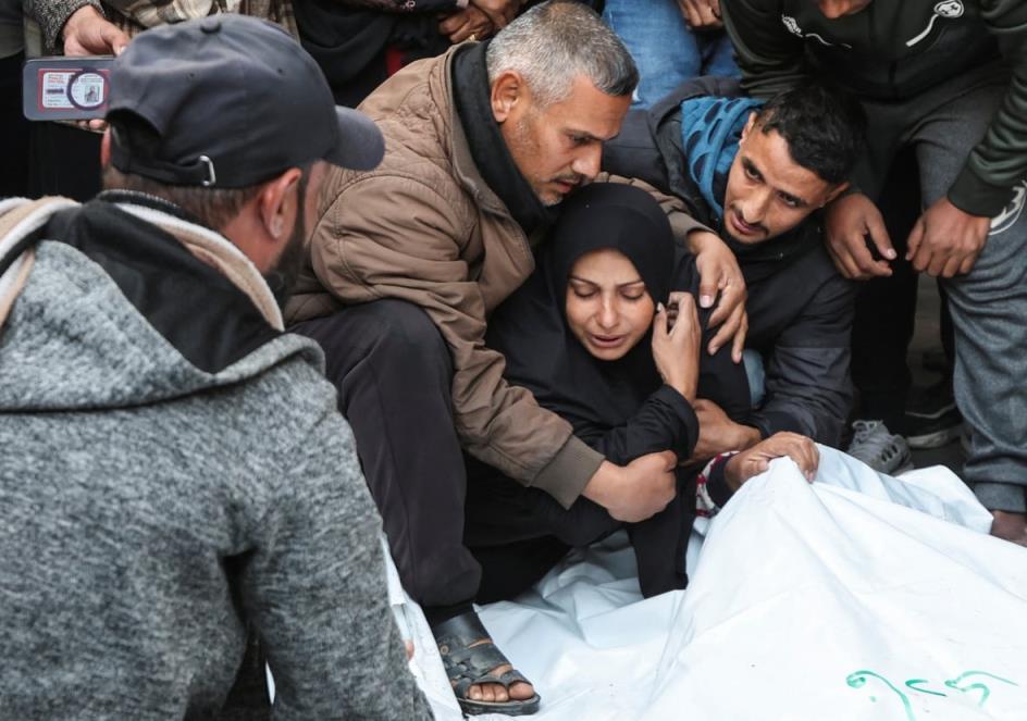 A woman is comforted as she mourns.