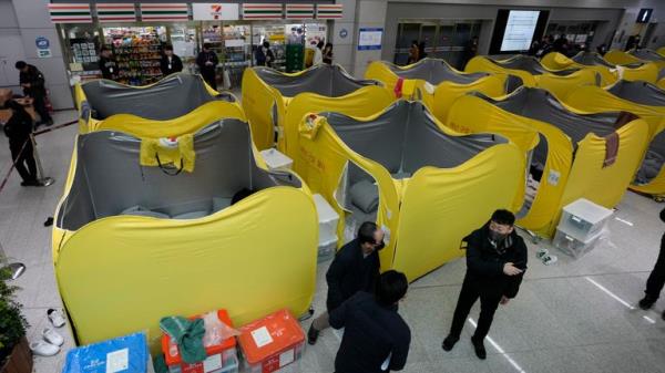 Temporary shelters set up at the airport for mourners waiting for answers.
Pic: AP/Ahn Young-joon