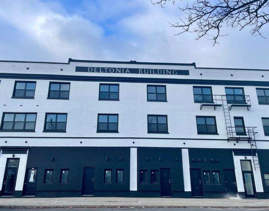 street view of apartment building painted black and white