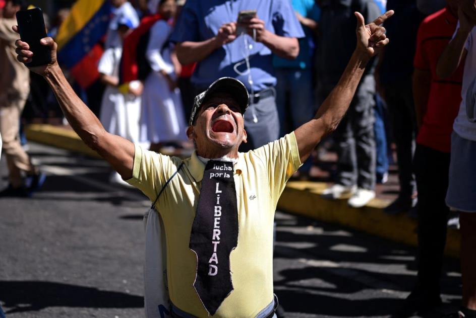 A man shouts with his hands in the air.