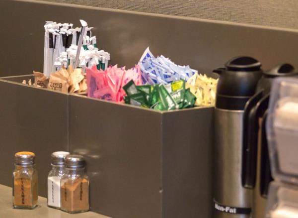 Counter in Starbucks cafe with Straws and sugar to pick up to go