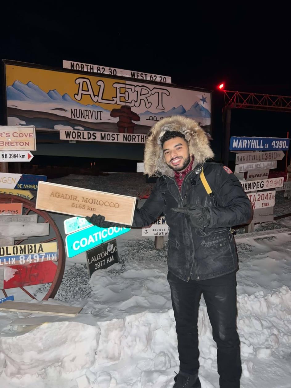 Aymane Amarir in Nunavut holding a sign that says 'Agadir'