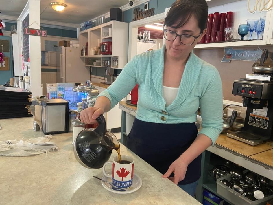 Jennifer MacMichael pours a cup of coffee at the diner she works at in St. Stephen, N.B.