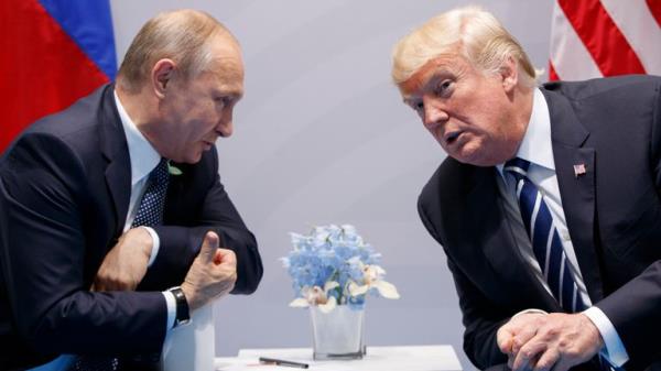 Do<em></em>nald Trump and Vladimir Putin in July 2017. Pic: AP