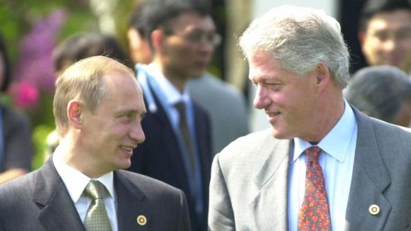 FILE - In this July 21, 2000 file photo, President Bill Clinton shares a light moment with Russian President Vladimir Putin before a Group of Eight meeting in Nago, Okinawa, Japan. In a series of interviews with American film director Oliver Stone being shown on U.S. television on Monday, June 12, 2017, Putin said that he inquired a<em></em>bout Russia joining NATO when Clinton visited Moscow in 2000. (AP Photo/Vincent Yu, File)