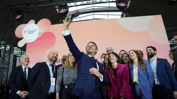 French President Emmanuel Macron takes a selfie during the summit. Pic: Reuters