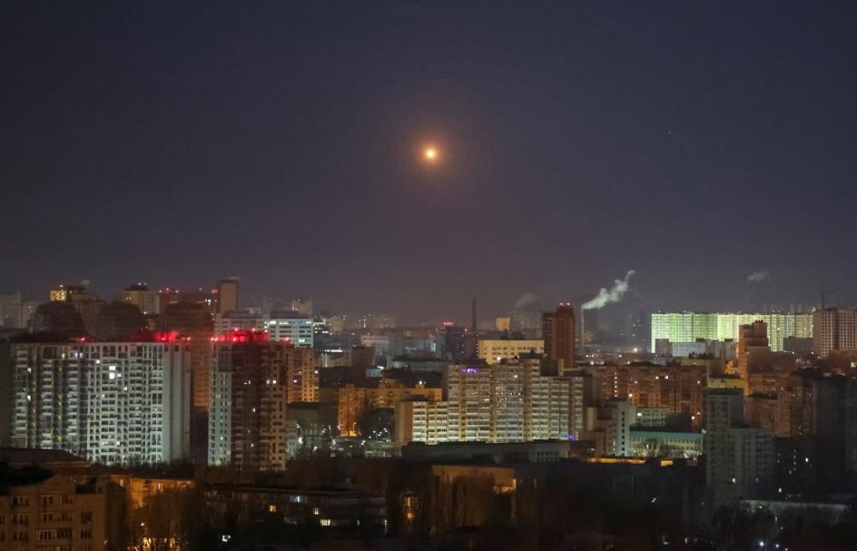 A nighttime cityscape is shown, with an orange ball above the city.