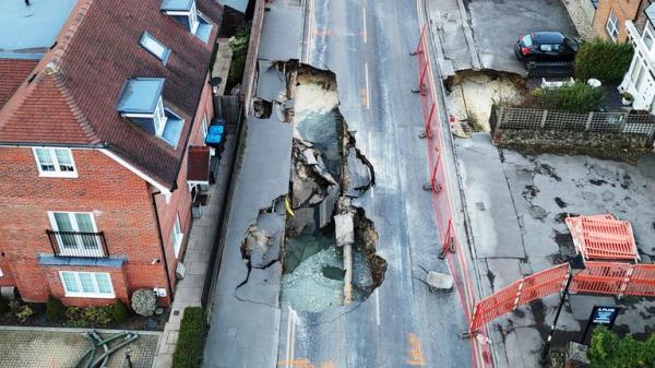 The scene in Godstone after a sinkhole appeared on Mo<em></em>nday night. The large sinkhole has forced the closure of the high street in the Surrey village. Surrey Police said on Tuesday that Godstone High Street was closed between Oxted Road and Bletchingley Road. The force added that a small number of buildings were evacuated as a precaution and a 100-metre cordon was put in place. Picture date: Tuesday February 18, 2025.

