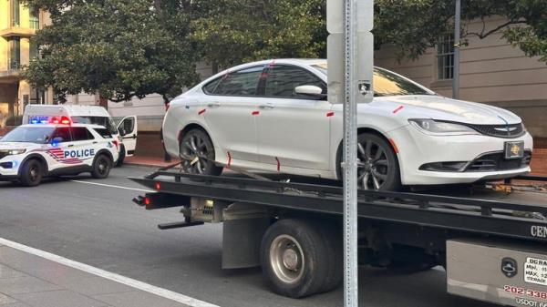 The armed man's vehicle being taken away by police