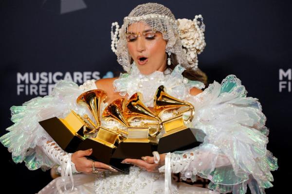 Sierra Ferrell poses in the press room with the Grammys for Best Americana Album, Best Americana Roots Song, Best Americana Performance and Best Americana Roots Performance.