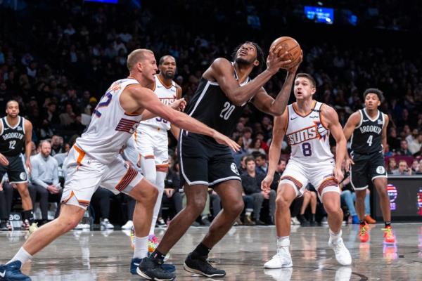 Brooklyn Nets center Day'Ron Sharpe (20) looks to shoot as Phoenix Suns center Mason Plumlee (22) defends in the second half at Barclays Center, Wednesday, Jan. 22, 2025, in Brooklyn, NY. 