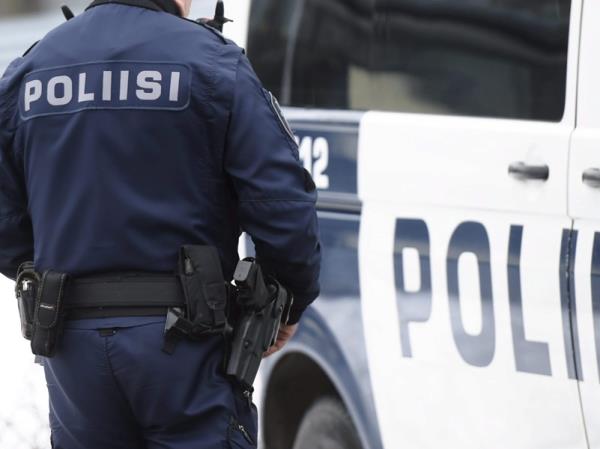 A police officer standing next to a police van during an exercise in Laajasalo, Helsinki, in March 2016.