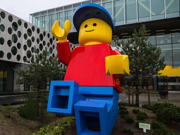 A huge LEGO figurine is pictured outside a building