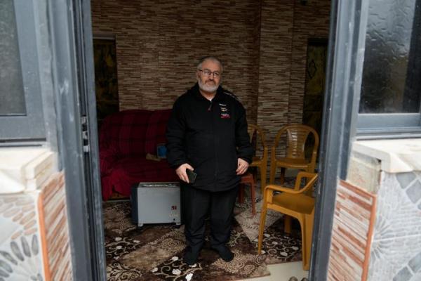 Mohammed Shula poses for a photo inside a relative's house, wher<em></em>e he and his wife have taken refuge at the West Bank village of Kafr al-Labad, on Monday, Feb. 10, 2025.