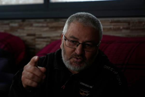 Mohammed Shula speaks at a relative's house, wher<em></em>e he and his wife have taken refuge, in the West Bank village of Kafr al-Labad, on Monday, Feb. 10, 2025.