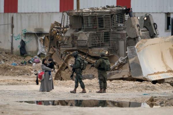 Israeli soldiers check the IDs of Palestinians in the West Bank refugee camp of Nur Shams, Tulkarem, as the military co<em></em>ntinues its operation in the area on Tuesday, Feb. 11, 2025.