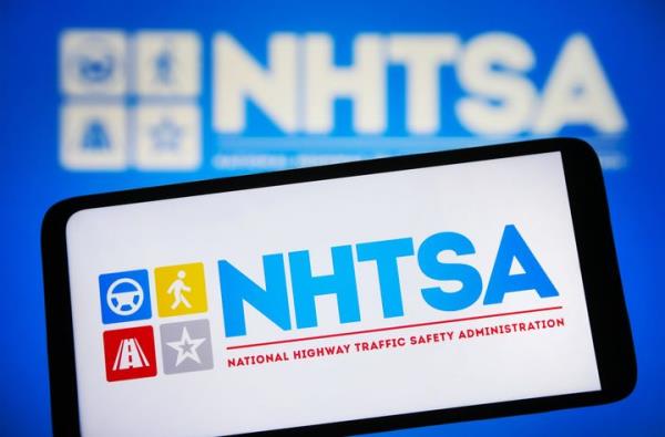 In this photo illustration, a Natio<em></em>nal Highway Traffic Safety Administration (NHTSA) logo is seen on a smartphone and on a pc screen. (Photo Illustration by Pavlo Gonchar/SOPA Images/LightRocket via Getty Images)