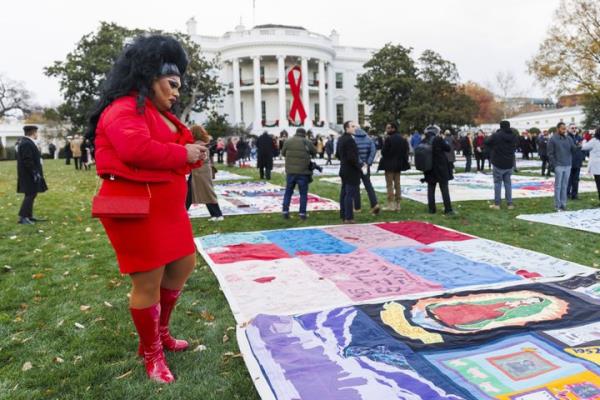 Attendees view the AIDS Memorial Quilt during an event to commemorate World AIDS Day on the South Lawn of the White House in Washington, D.C., on Dec. 1, 2024.