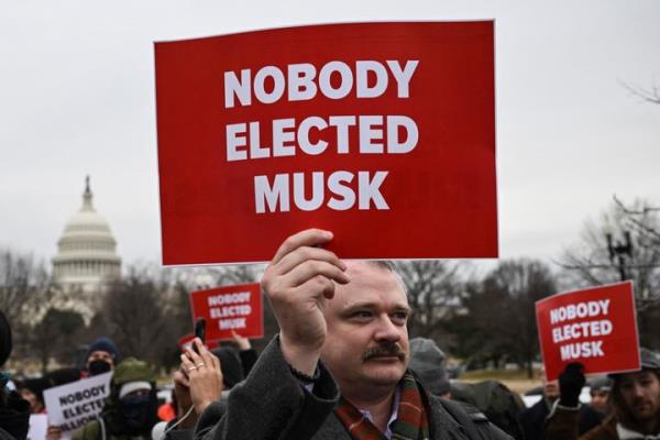 People protest against President Do<em></em>nald Trump and Elon Musk's no<em></em>nofficial Department of Government Efficiency on Wednesday near the U.S. Capitol.