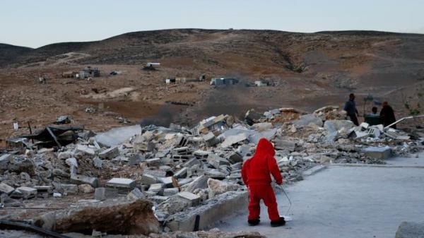 A child walking by the rubble of a demolished home in Masafer Yatta. In recent years, the Israeli government has more aggressively forced residents out of their homes.